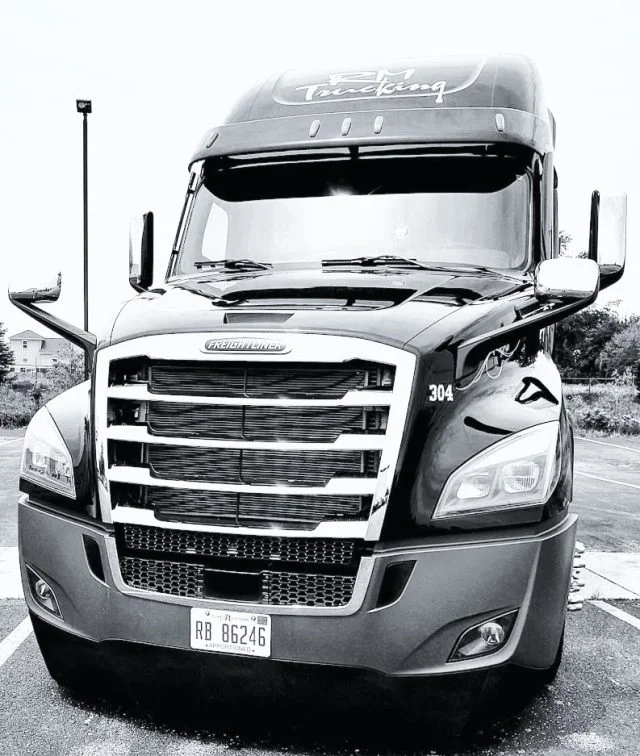 Front of a RM Trucking Semi Cab in Black and white