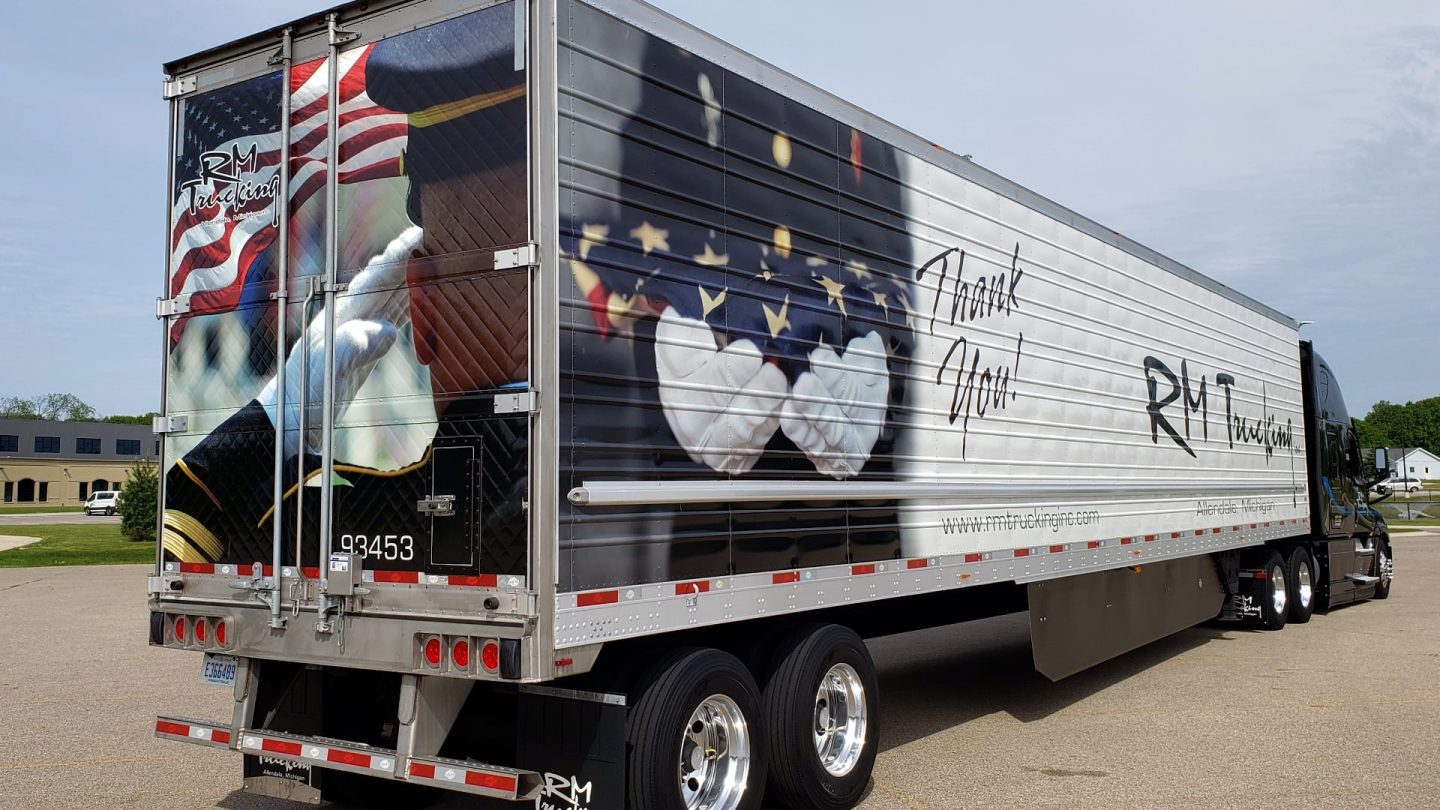 A RM Trucking trailer with a thank you message to our vets written on it