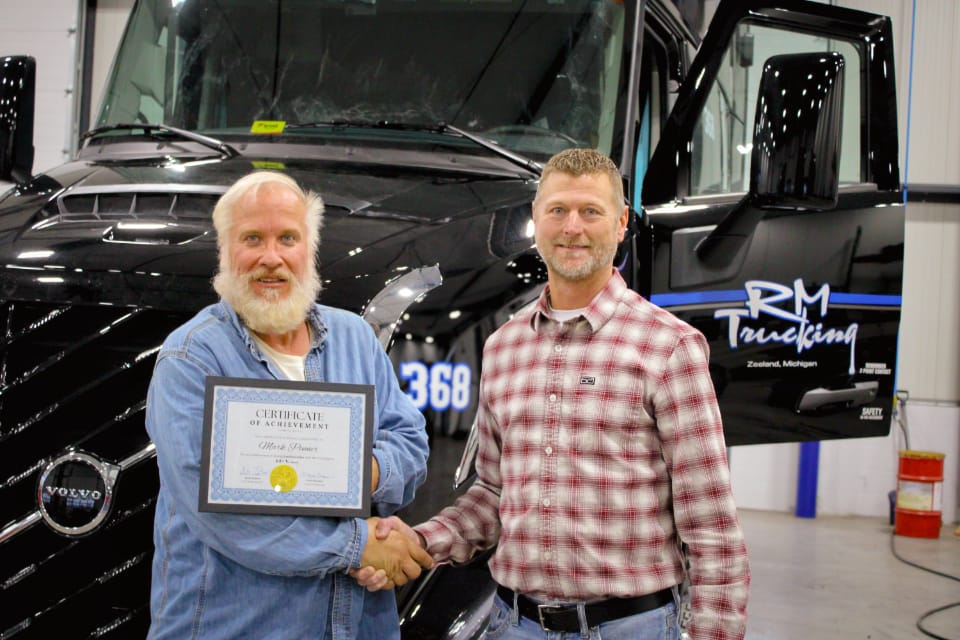 RM Trucking driver being presented with a certificate of achievement.